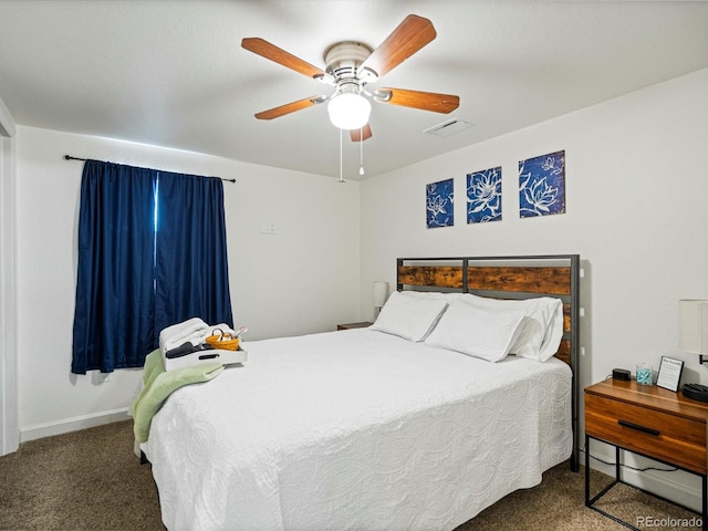 carpeted bedroom featuring baseboards, a ceiling fan, and visible vents