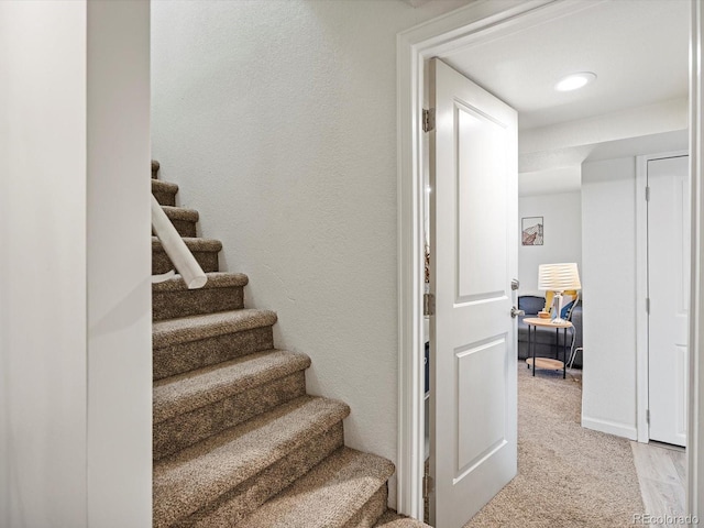 stairs featuring carpet