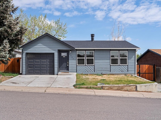 single story home featuring fence, an attached garage, concrete driveway, and a shingled roof