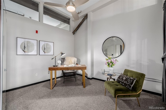 carpeted home office featuring ceiling fan