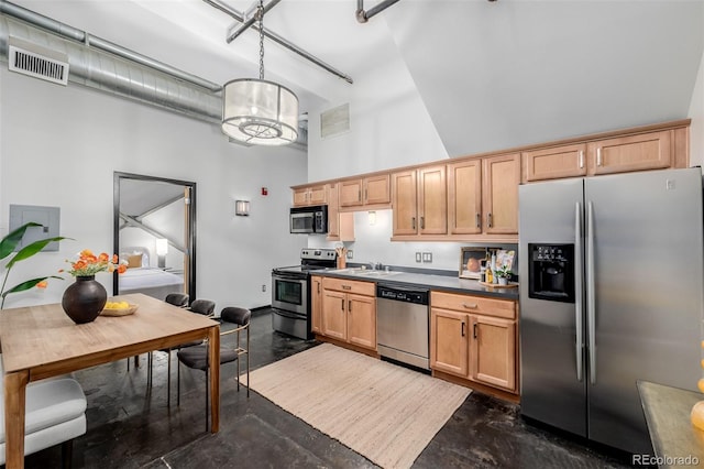 kitchen featuring light brown cabinets, decorative light fixtures, sink, a towering ceiling, and stainless steel appliances