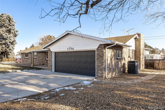 view of front of house with a garage and cooling unit