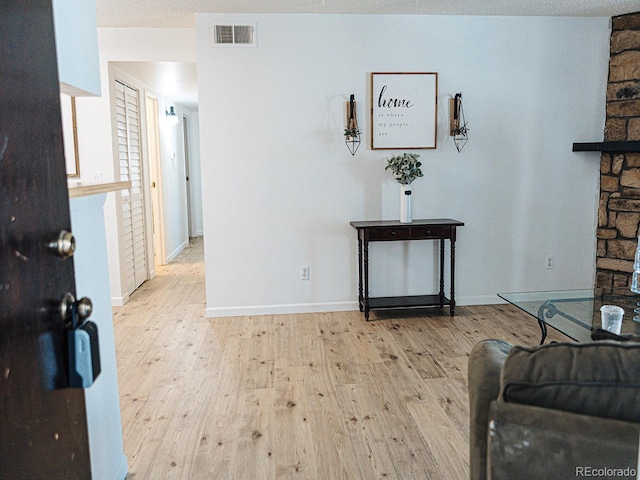 interior space featuring a textured ceiling and light wood-type flooring