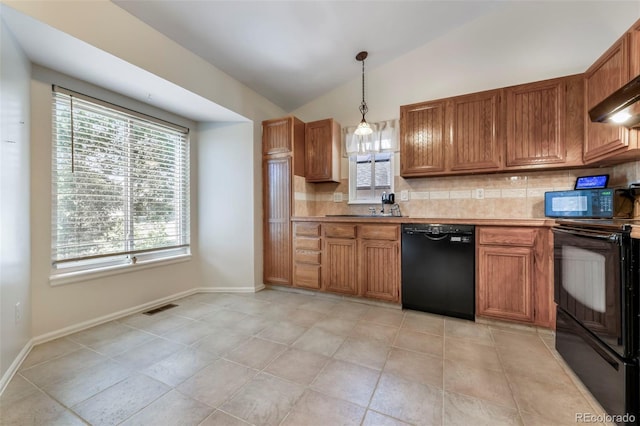 1024 Bromefield Dr, Fountain, CO 80817 - kitchen featuring black appliances, tasteful backsplash, lofted ceiling, brown cabinets, and pendant lighting