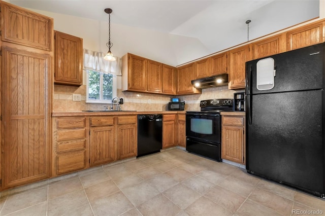 1024 Bromefield Dr, Fountain, CO 80817 - kitchen featuring black appliances, under cabinet range hood, backsplash, vaulted ceiling, and brown cabinets