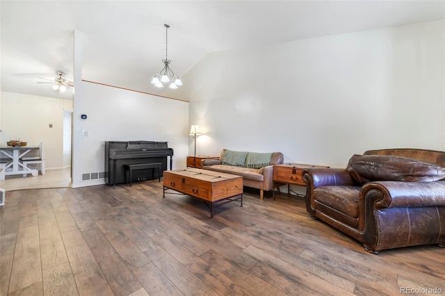 1024 Bromefield Dr, Fountain, CO 80817 - living area featuring vaulted ceiling, hardwood / wood-style flooring, ceiling fan, and a chandelier