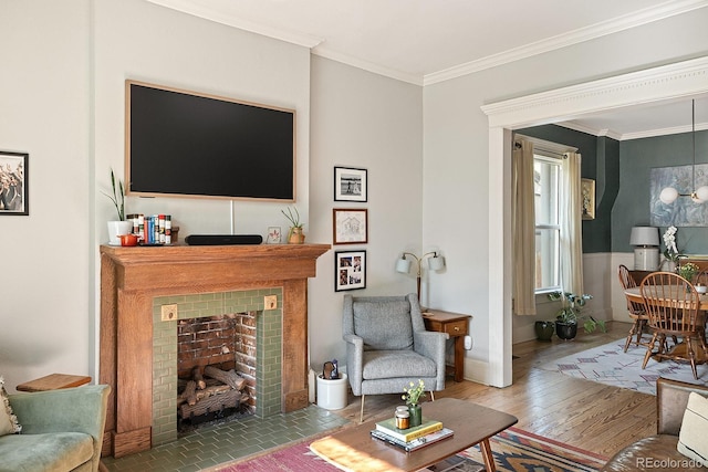 2445 N Franklin St, Denver, CO 80205 - living area featuring a tiled fireplace, ornamental molding, and wood finished floors