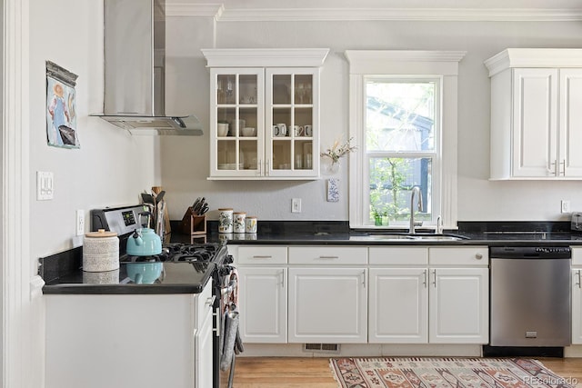 2445 N Franklin St, Denver, CO 80205 - kitchen featuring stainless steel appliances, ventilation hood, dark countertops, ornamental molding, and white cabinets