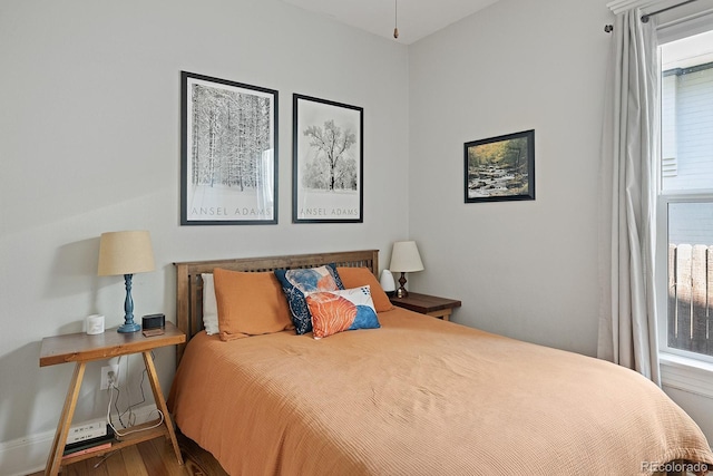 2445 N Franklin St, Denver, CO 80205 - bedroom with multiple windows and wood finished floors