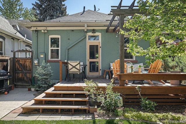 2445 N Franklin St, Denver, CO 80205 - rear view of house featuring brick siding, a wooden deck, and a gate