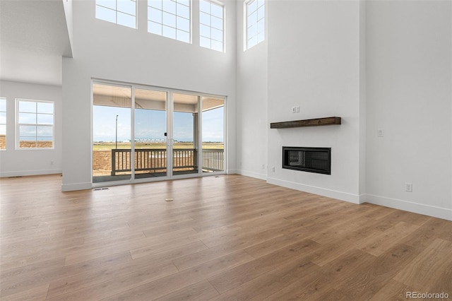 unfurnished living room with plenty of natural light and light hardwood / wood-style floors