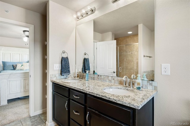 full bathroom with a sink, a stall shower, ensuite bath, and tile patterned floors