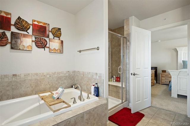 full bathroom featuring tile patterned floors, a shower stall, and a garden tub