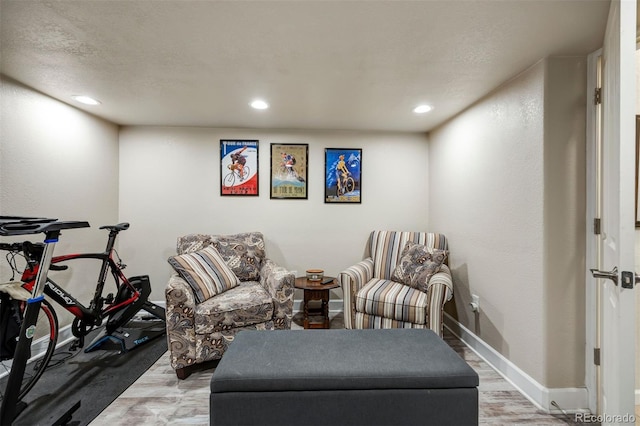 sitting room featuring wood finished floors, recessed lighting, and baseboards