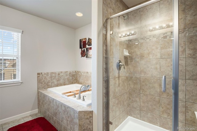 bathroom with baseboards, a bath, a shower stall, and tile patterned flooring