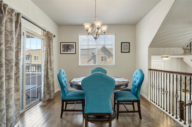 dining space with a wealth of natural light, baseboards, an inviting chandelier, and hardwood / wood-style floors