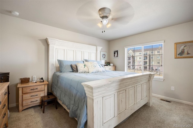 bedroom with visible vents, light colored carpet, a ceiling fan, and baseboards