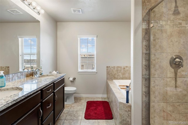 bathroom with visible vents, plenty of natural light, tiled shower, and a sink