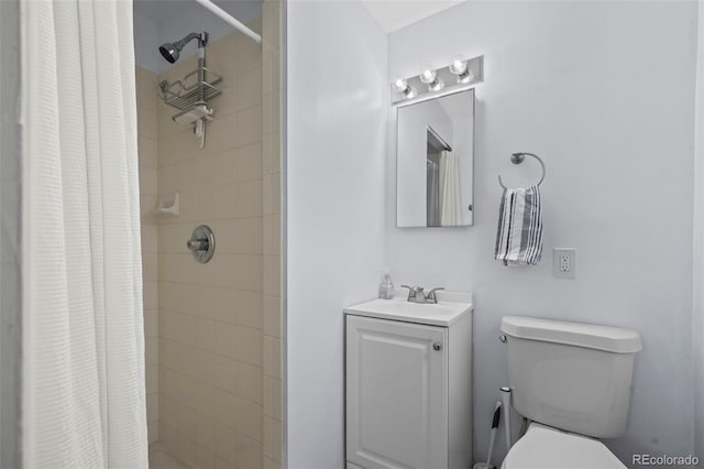 bathroom with curtained shower, vanity, and toilet