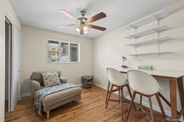 home office featuring ceiling fan and light hardwood / wood-style flooring