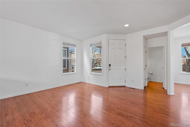 unfurnished room with hardwood / wood-style flooring