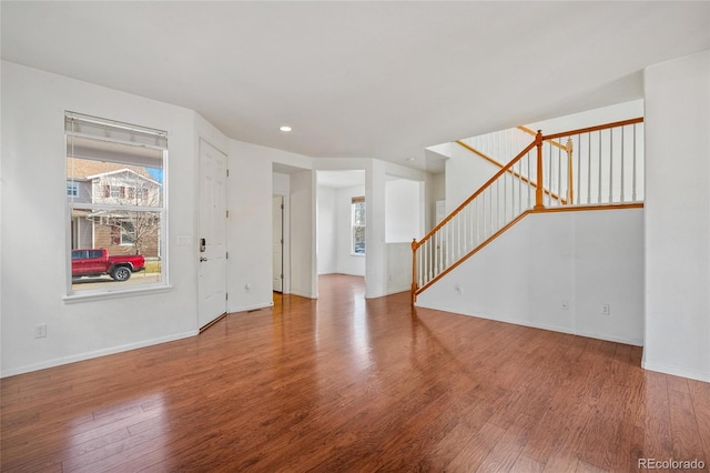 unfurnished room featuring hardwood / wood-style floors and a healthy amount of sunlight