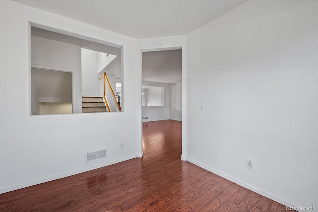 empty room with dark wood-type flooring