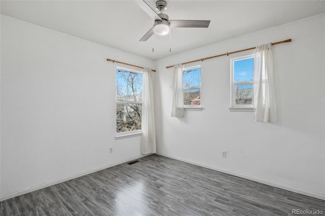 empty room featuring ceiling fan and dark wood-type flooring