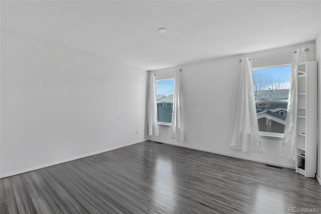 unfurnished room featuring dark wood-type flooring