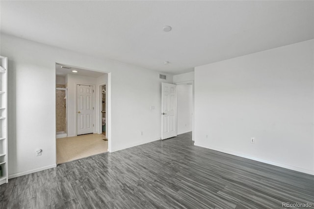 unfurnished room featuring dark wood-type flooring