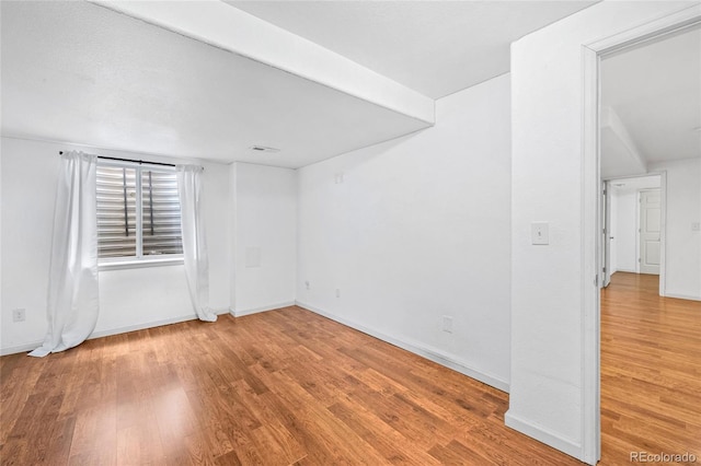 spare room featuring hardwood / wood-style floors