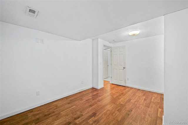 empty room with light hardwood / wood-style flooring