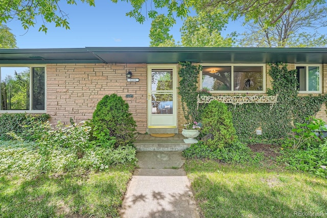 8600 W 2nd Ave, Lakewood, CO 80226 - doorway to property featuring brick siding