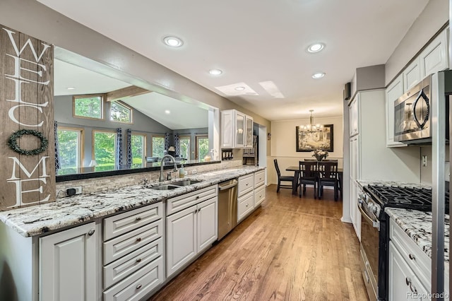 8600 W 2nd Ave, Lakewood, CO 80226 - kitchen featuring appliances with stainless steel finishes, a sink, a chandelier, healthy amount of natural light, and recessed lighting