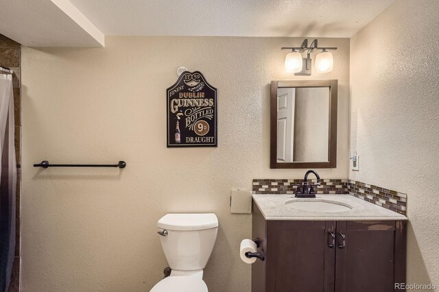 8600 W 2nd Ave, Lakewood, CO 80226 - full bath featuring vanity, toilet, decorative backsplash, and a shower with shower curtain