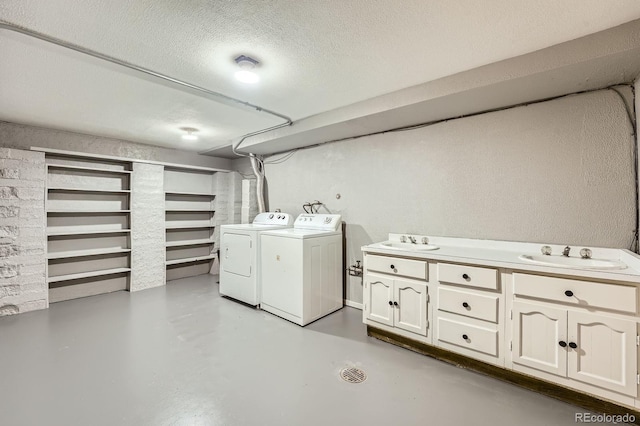 8600 W 2nd Ave, Lakewood, CO 80226 - laundry room featuring washer and clothes dryer, cabinet space, and a textured ceiling