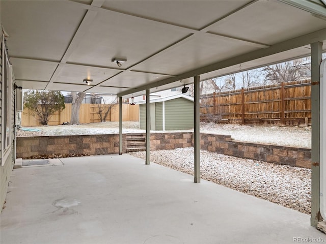 view of patio featuring an outbuilding, a storage shed, and a fenced backyard