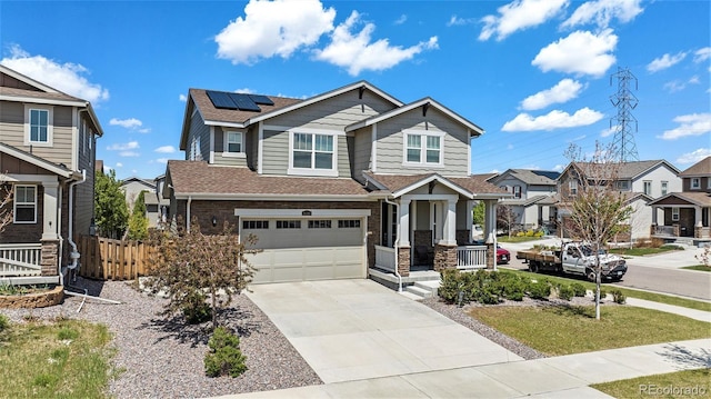 26385 E Canal Pl, Aurora, CO 80018 - craftsman-style home featuring roof mounted solar panels, concrete driveway, fence, a residential view, and a garage