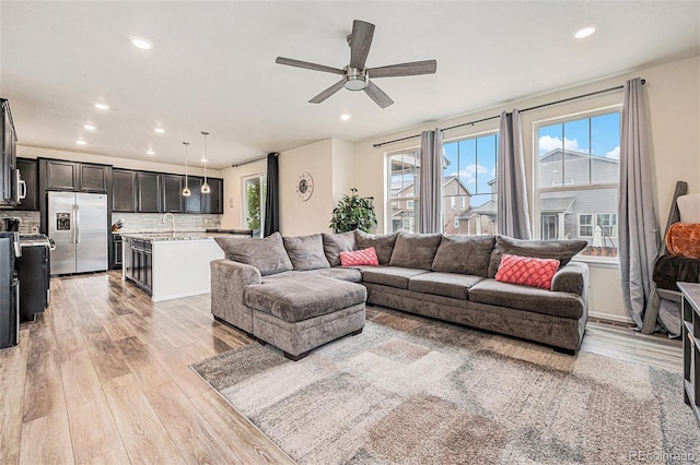 26385 E Canal Pl, Aurora, CO 80018 - living room with light wood-style floors, a ceiling fan, and recessed lighting