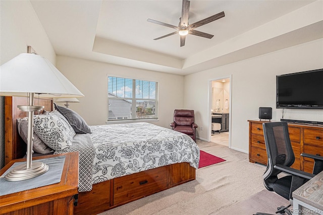 26385 E Canal Pl, Aurora, CO 80018 - bedroom featuring carpet floors, a tray ceiling, baseboards, ensuite bathroom, and a ceiling fan