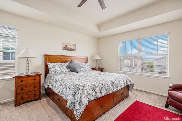 26385 E Canal Pl, Aurora, CO 80018 - bedroom with light carpet, baseboards, a ceiling fan, and a tray ceiling