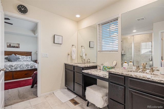 26385 E Canal Pl, Aurora, CO 80018 - bathroom with a shower stall, healthy amount of natural light, tile patterned floors, and ensuite bathroom