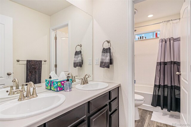 26385 E Canal Pl, Aurora, CO 80018 - bathroom with wood finished floors, toilet, shower / tub combo, and double vanity