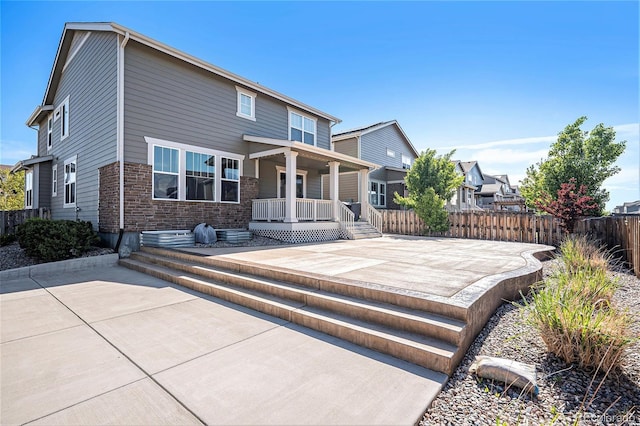 26385 E Canal Pl, Aurora, CO 80018 - rear view of house with fence, a porch, and a patio area