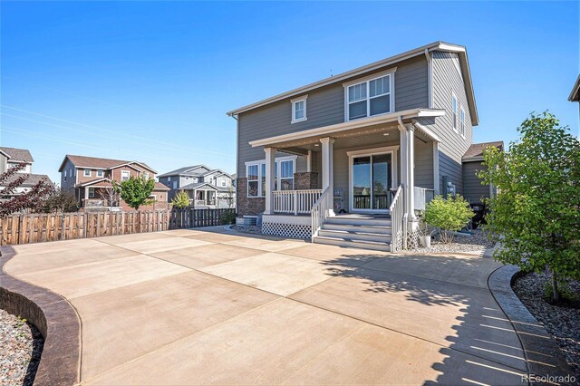 26385 E Canal Pl, Aurora, CO 80018 - view of front facade featuring covered porch, fence, and a residential view