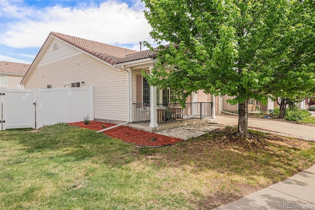 19481 E 50th Pl, Denver, CO 80249 - view of side of property featuring a tile roof, a gate, a porch, and concrete driveway
