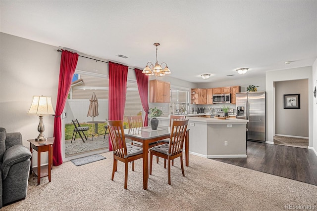 19481 E 50th Pl, Denver, CO 80249 - dining room featuring a chandelier, baseboards, and dark wood finished floors