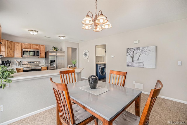19481 E 50th Pl, Denver, CO 80249 - dining room featuring washer / clothes dryer, carpet flooring, a chandelier, and baseboards