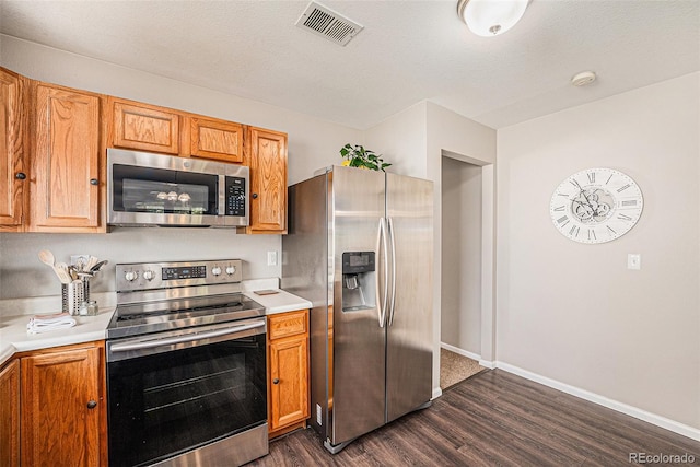 19481 E 50th Pl, Denver, CO 80249 - kitchen with appliances with stainless steel finishes, dark wood-style flooring, light countertops, and baseboards