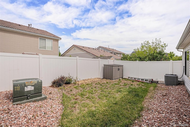 19481 E 50th Pl, Denver, CO 80249 - fenced backyard featuring central AC unit, a storage shed, and an outdoor structure